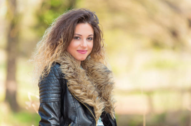 istock Beautiful woman relaxing in park 1210570934