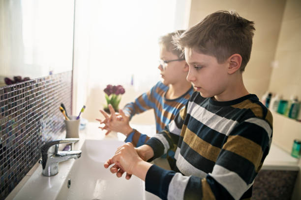 Little boys washing hands thoroughly