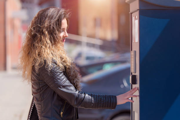istock Young woman paying for parking 1210572327