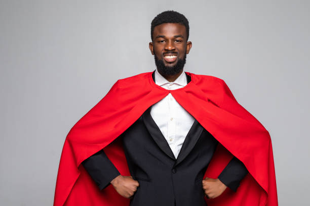 istock African businessman superman isolated on gray background 1210572482