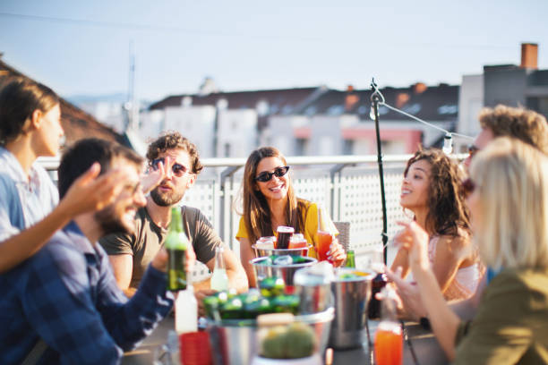 istock Cheerful friends enjoying at rooftop party. 1210573652