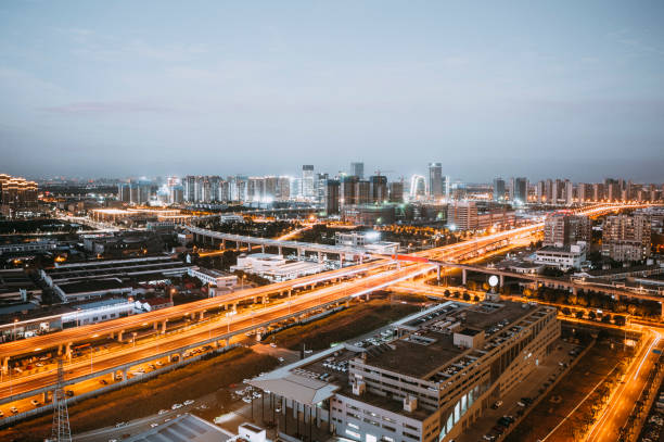 istock Freeway in night with cars light in modern city. 1210575167