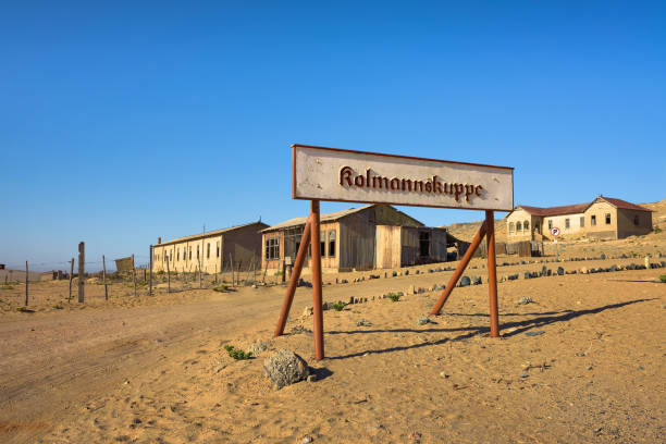 Welcome sign at the ghost town of Kolmanskop, Namibia Welcome sign at the entrance to ghost town of Kolmanskop, in german called Kolmanskuppe, located in the Namib desert near Luderitz in Namibia, Southern Africa kolmanskop namibia stock pictures, royalty-free photos & images
