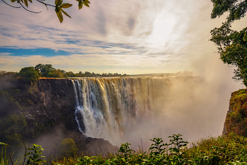 Sunset at the Victoria Falls on Zambezi River located between Zambia and Zimbabwe, the largest waterfall in the world.