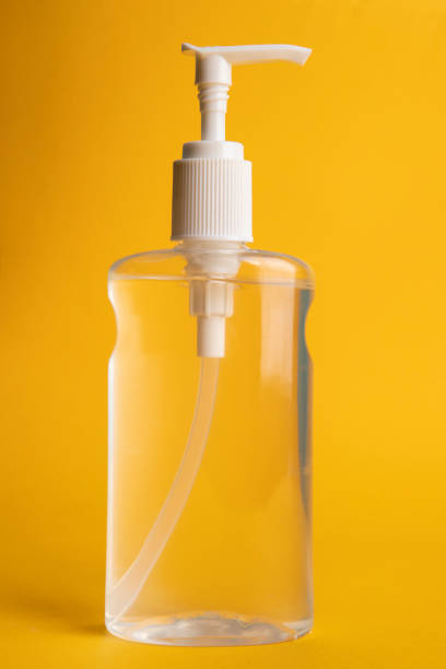 full hand sanitizer on yellow - hand sanitizer liquid soap hygiene healthy lifestyle imagens e fotografias de stock