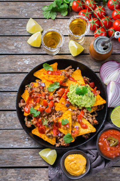 istock Chips nachos with beef, guacamole, chili, cheese salsa, tequila 1210580424