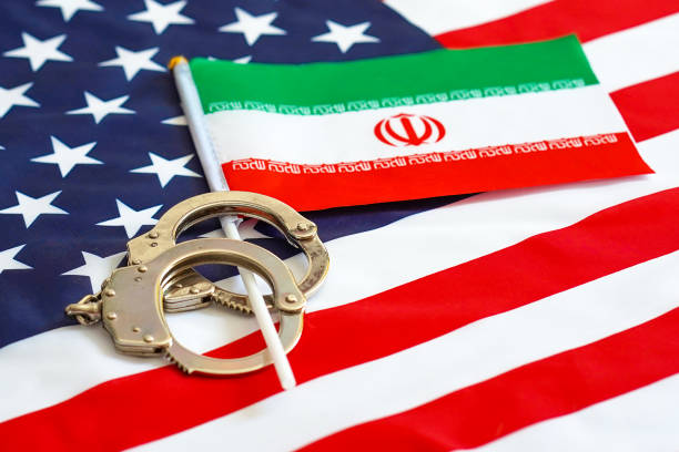 Flag of USA and Iran. Handcuffs. Sanctions. Iranian flag in handcuffs on the background of the American flag. US sanctions against Iran. iran stock pictures, royalty-free photos & images