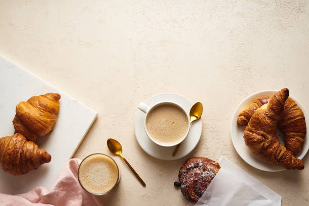 istock Flatlay with coffee and croissants. Breakfast beverage with pastry. Morning set with copy space 1210581735
