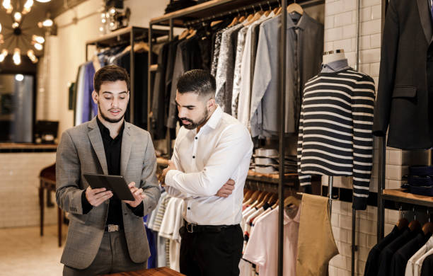 istock Young man choosing a suit style from a digital tablet 1210582372