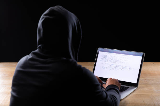 istock Caucasian man working on laptop on black background 1210584549