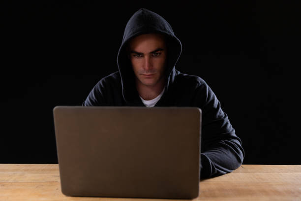istock Caucasian man working on laptop on black background 1210584584