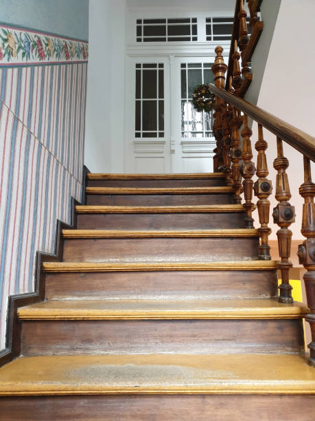 istock Old rustic wooden staircase in a hallway stairwell 1210584713