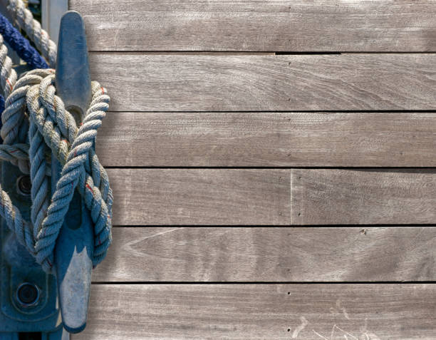 Mooring cleat with cord  on a wooden pier with lots of copy space