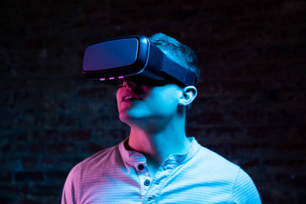 istock Caucasian man holding a Virtual Reality headset 1210584726