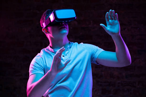 istock Caucasian man holding a Virtual Reality headset 1210584758