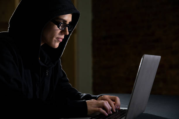 istock Caucasian woman working on a laptop computer in the dark 1210584857