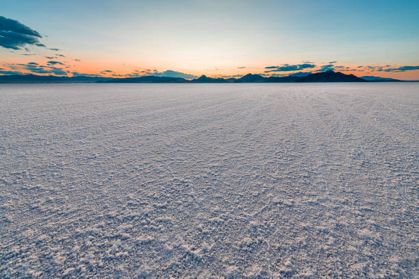 Bonneville Salt Flats colorful landscape twilight sunset near Salt Lake City, Utah and silhouette view of mountains and sun setting behind clouds Bonneville Salt Flats colorful landscape twilight sunset near Salt Lake City, Utah and silhouette view of mountains and sun setting behind clouds bonneville salt flats stock pictures, royalty-free photos & images