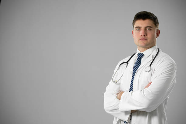 istock Caucasian male doctor on grey background 1210586007