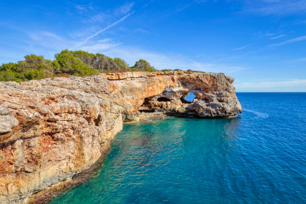 Peninsula with rock hole " Es Puntás " near by Cala Sa Nau on the Spanish Balearic island of Majorca - Spain
