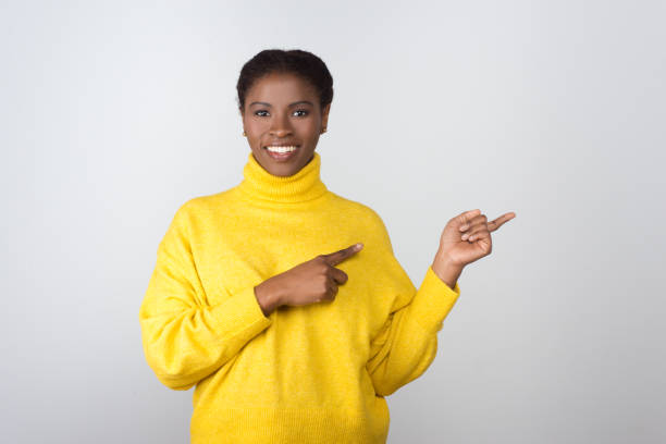 istock Content young woman pointing away 1210587936