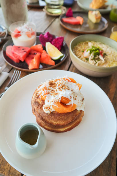 istock Vegan Coconut Banana Pancakes with Mango at tropical Breakfast Table 1210588050