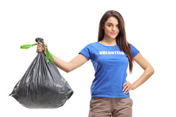istock Female volunteer holding a plastic waste bag 1210593054