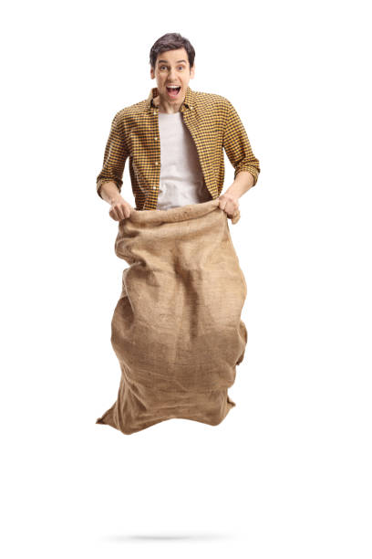 istock Excited young man playing a sack race 1210593055