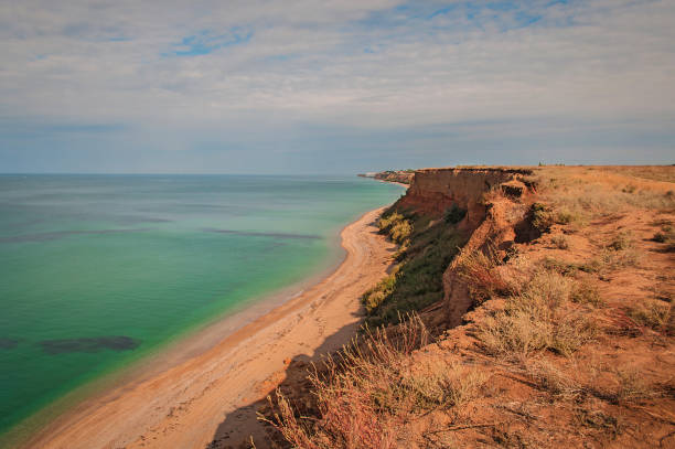 istock Colorful empty sand beach with emerald clear water 1210594018