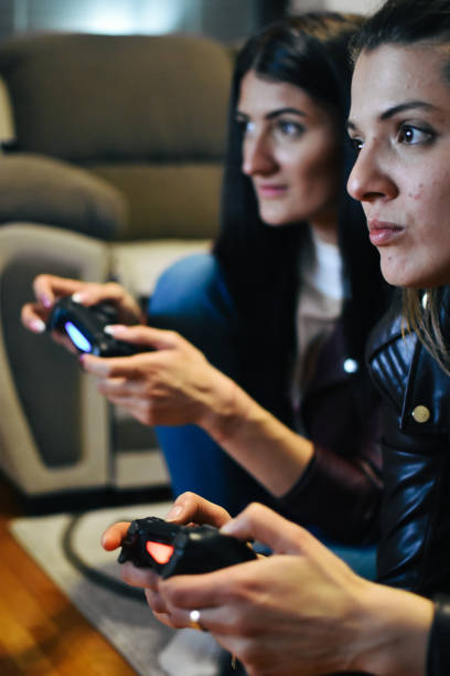 istock Young Women Playing a Video Game 1210594247