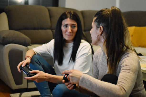 istock Young Women Playing a Video Game 1210594340