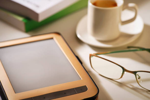 istock E-reader with cup of coffee and glasses 1210597292