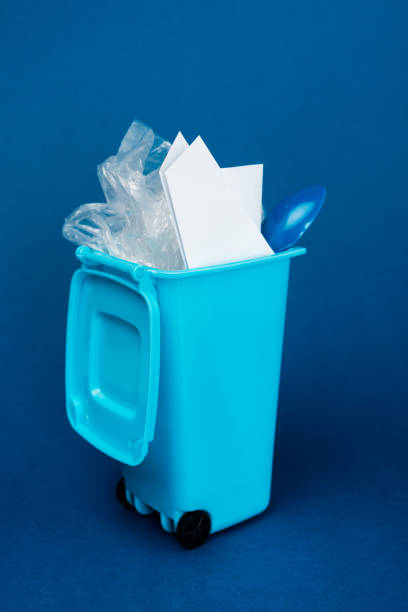 istock toy trash can with rubbish on blue background 1210597951
