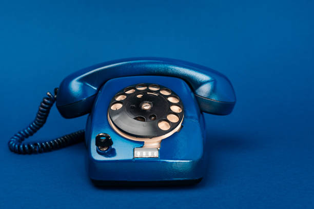 istock bright and colorful retro telephone on blue background 1210598491