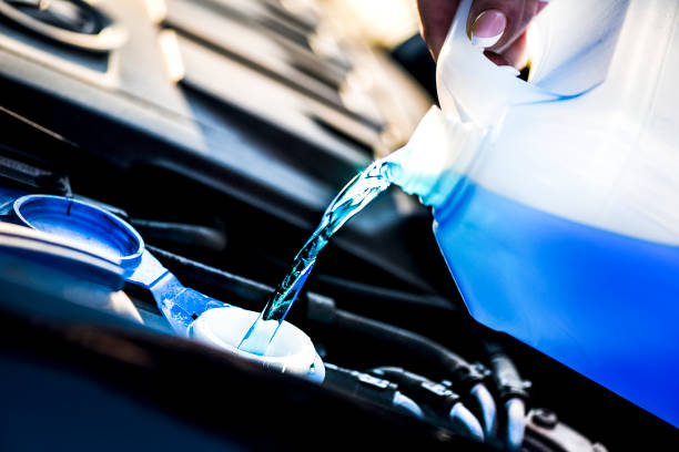 Pouring antifreeze liquid screen wash detail. Pouring antifreeze liquid screen wash windshield wiper photos stock pictures, royalty-free photos & images