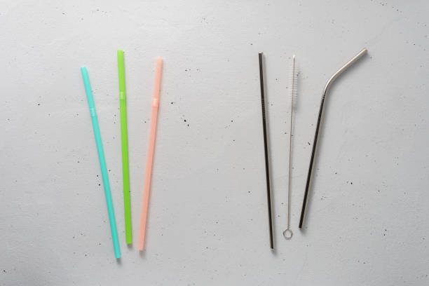 istock Plastic and metal cocktail tubes and cleaning brushes on a light gray background. 1210598637