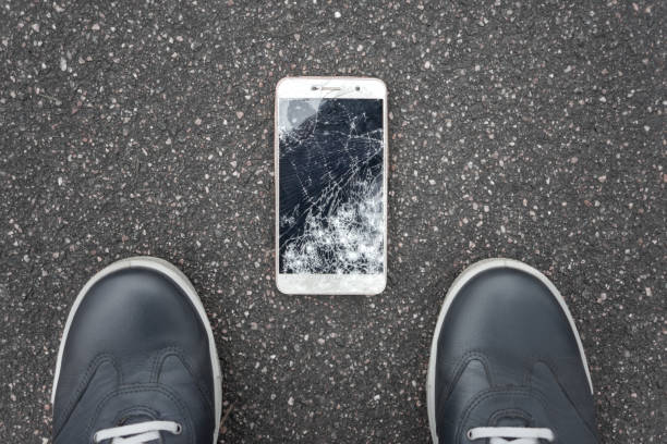 istock Broken smartphone on the pavement. Point of view. 1210598648