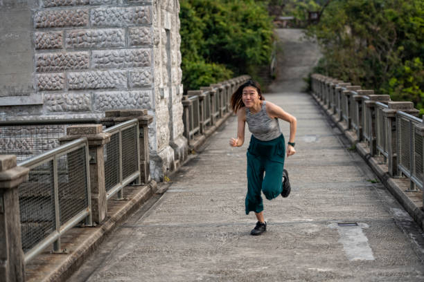 istock Young Asian woman runs for fun 1210599361