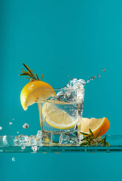 istock Cocktail gin-tonic with lemon and rosemary on a glass table. 1210600003