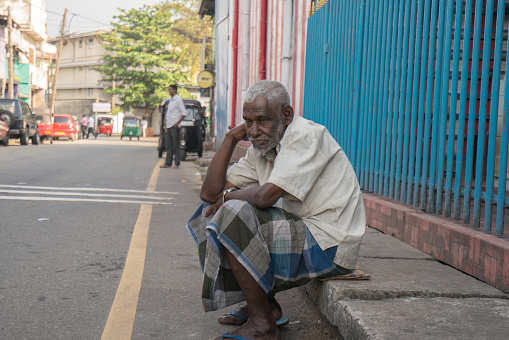 Colombo,Sri Lanka-January 28,2020: A homeless man sits in street of  Colombo, Sri Lanka