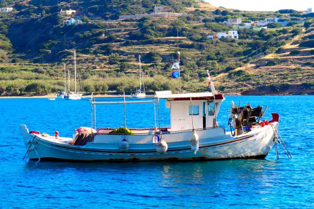 traditional fishing boat (or caique) in the small bay of Kini in Syros, famous island of Cyclades, in the heart of the Aegean Sea.