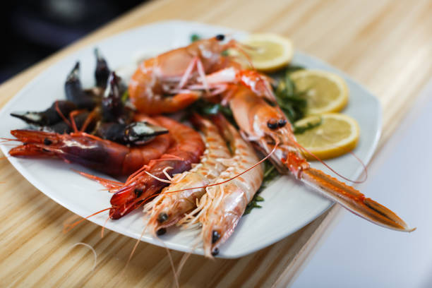 istock Plate with cooked shrimps, langoustines, clams 1210603270