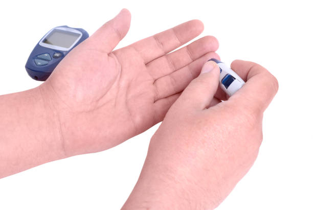istock Blood test. Man hands checking blood sugar level by Glucose meter. 1210604187