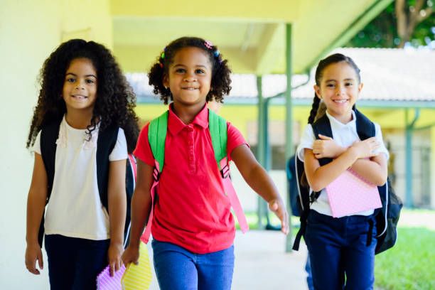 istock Smiling female Hispanic students walking together at school 1210604312