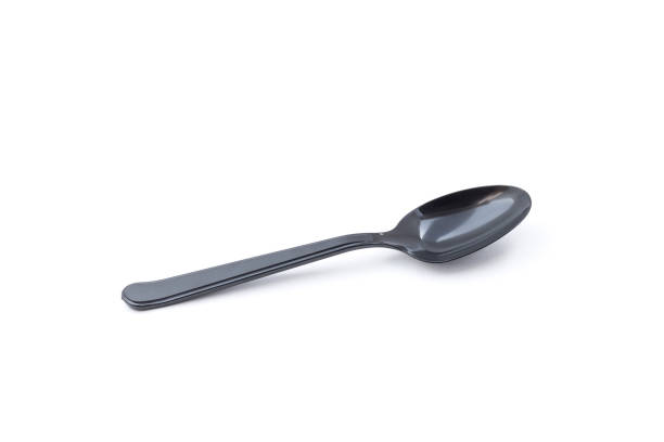 istock Single small black plastic baby teaspoon isolated from white background 1210605671
