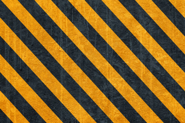 black and yellow safety hazard attention warning stripes on cement wall