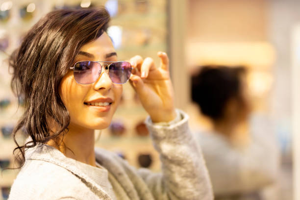 istock happy woman trying some eyeglasses 1210612647