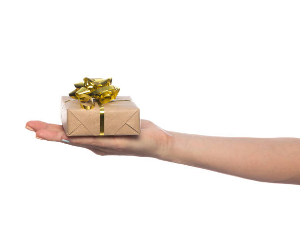 istock female hand holds a beautiful gift box with a bow isolated on white background 1210617065