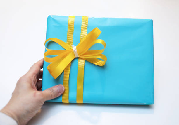 istock Blue Gift Box with Yellow and White Ribbon 1210619768