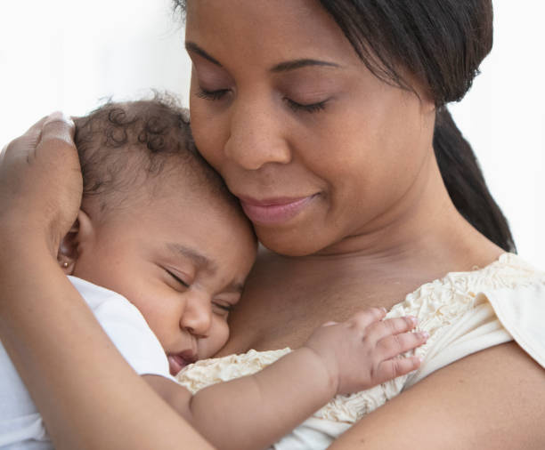 istock Mother holding her sleeping daughter 1210620476