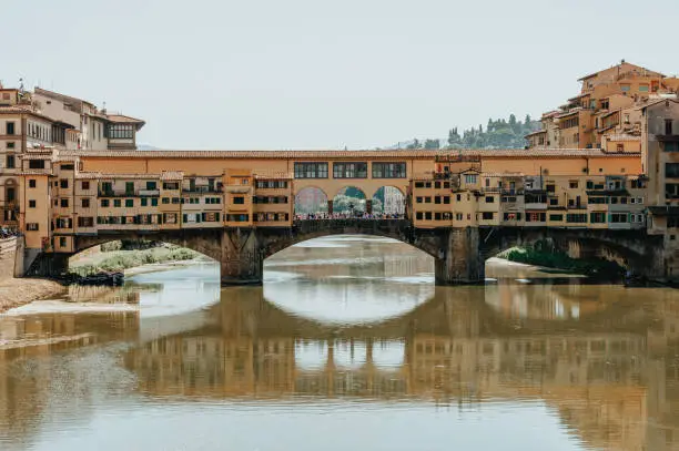 Photo of The famous Ponte Vecchio bridge. Florence, Italy. The concept of tourism, recreation.